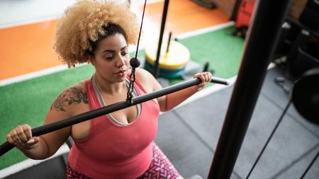 Mulher fazendo musculação; pulley costas - iStock - iStock