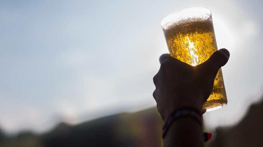 LollaBR vai ter tenda exclusiva para a venda de cerveja; na foto acima, homem ergue copo de cerveja no Lollapalooza Berlim em 2016