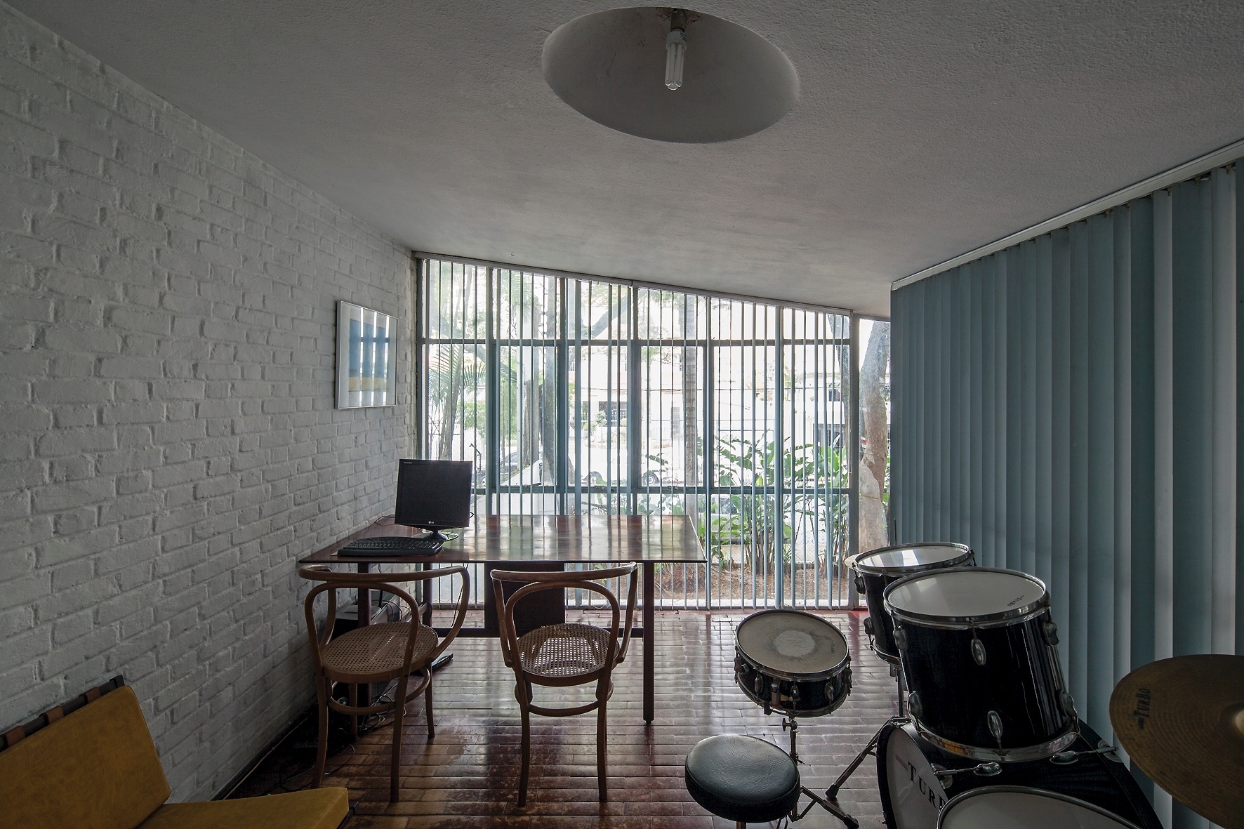 Do antigo escritório, com fechamento em vidro, é possível observar toda a movimentação da casa, exceto quando a persiana vertical está fechada. A inclinação da cobertura é um dos destaques da Casa do Arquiteto, projetada por João Batista Vilanova Artigas (1915-1985), que faria 100 anos em 23 de junho de 2015 - Leonardo Finotti/ UOL