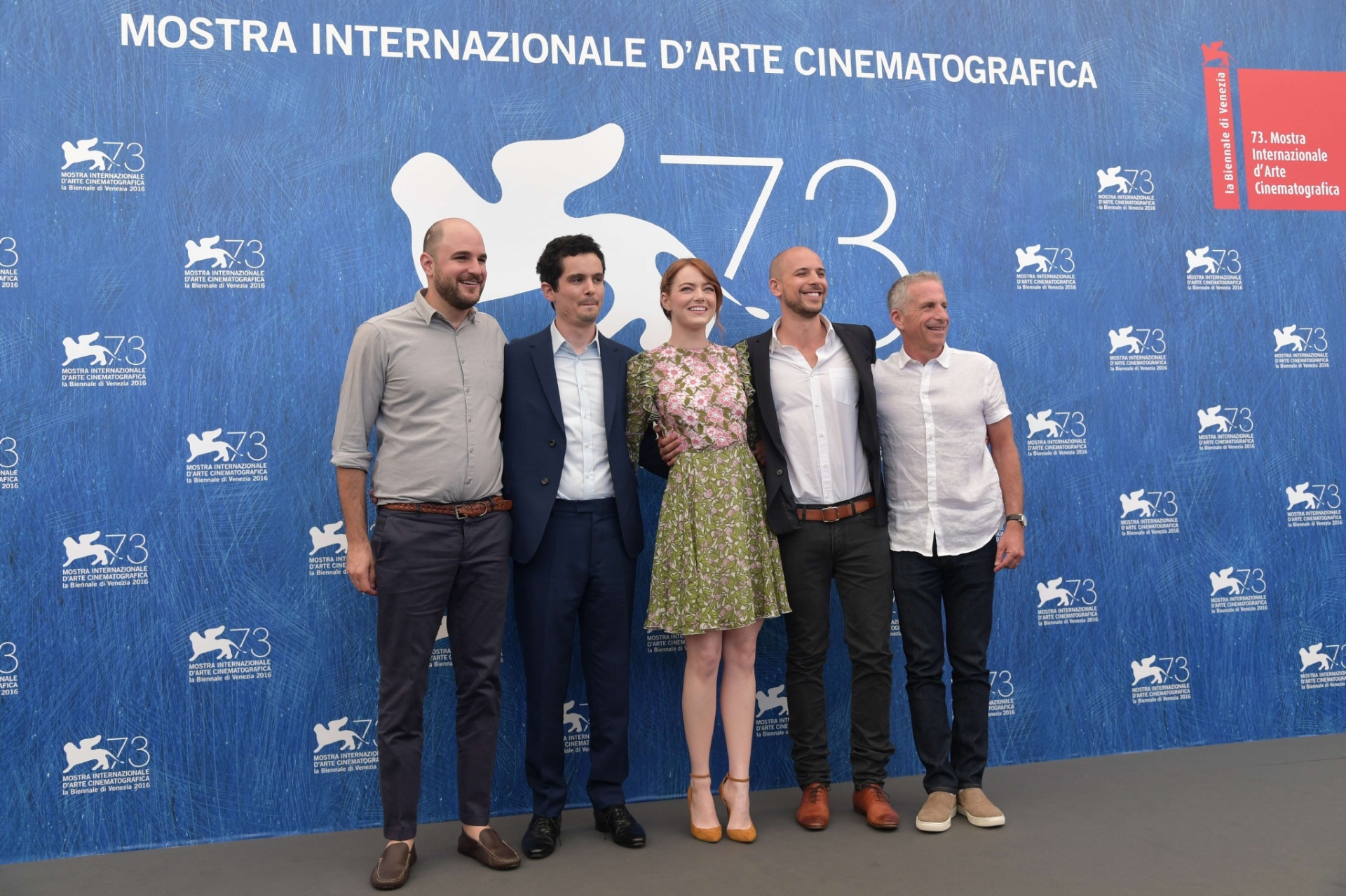 31.ago.2016 - A atriz Emma Stone (ao centro) posa entre a equipe do filme "La La Land", que abriu o Festival de Veneza - Tiziana Fabi/AFP