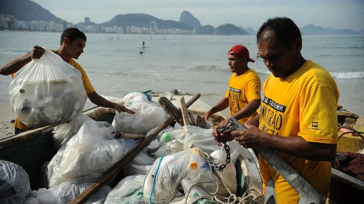 Pescadores da colônia Z13, no Rio de Janeiro, trazem para a praia de Copacabana barco com lixo recolhido por um mutirão de limpeza feito nas Ilhas Cagarras