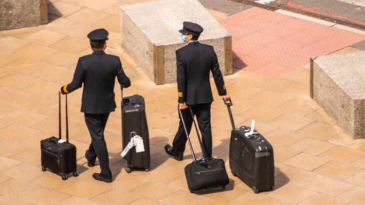 Pilotos usam máscaras ao chegarem no aeroporto de Manchester, na Inglaterra, durante a pandemia do coronavírus - Getty Images