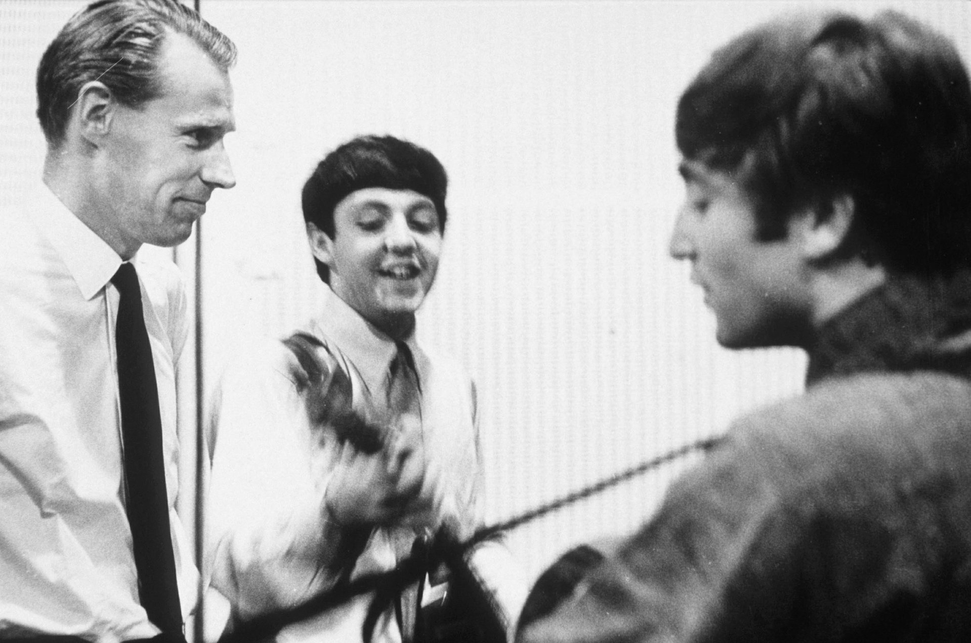 Paul McCartney e John Lennon conversam com George Martin em 1964 - Terry O'Neill/Rex/Shutterstock