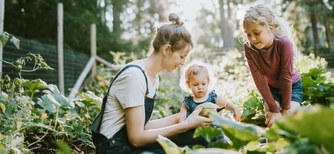 Mãe e a filhas cultivam horta: incentivo ao contato com a natureza - Getty Images