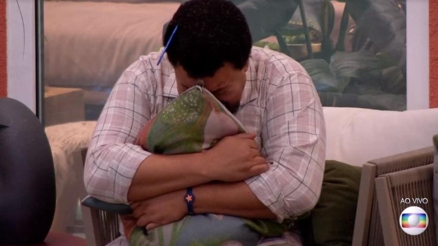 Após escapar do seu oitavo paredão, Babu chora abraçado a uma almofada que ele apelidou de Wilson  - Reprodução/TV Globo