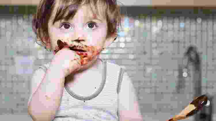 Criança comendo chocolate - iStock - iStock