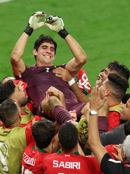 Jogadores de Marrocos erguem o goleiro Yassine Bounou, heroi contra a Espanha - Patrick Smith - FIFA/Getty Images