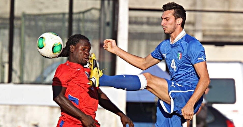 11.jun.2013 - Saint (esq.), do Haiti, disputa a bola com Astori, da Itália, em amistoso no Rio de Janeiro, em São Januário