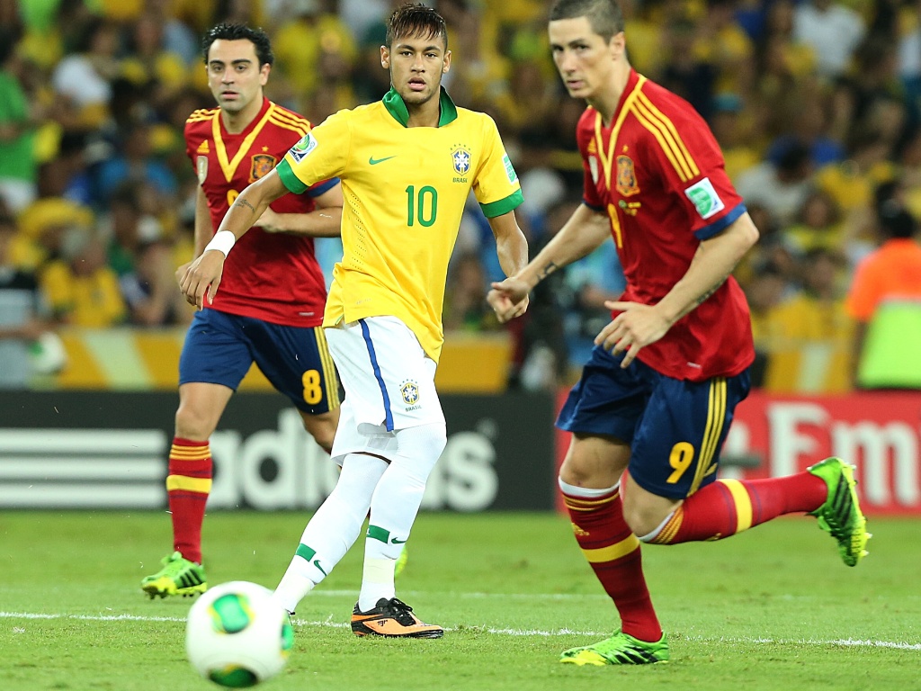 30.jun.2013 - Observado por Torres e Xavi, Neymar toca a bola durante final entre Brasil e Espanha