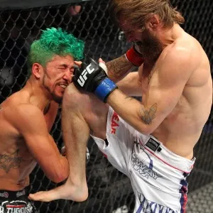 31.ago.2013 - Tim Elliott acerta joelhada em cheio Louis Gaudinot no UFC 164 - Ed Mulholland/Zuffa LLC/Getty Images