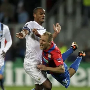 17.09.2013 - Zagueiro Kompany, do Manchester City, derruba Daniel Kolar, do Viktoria Plzen, em jogo da Liga dos Campeões - REUTERS/David Cerny