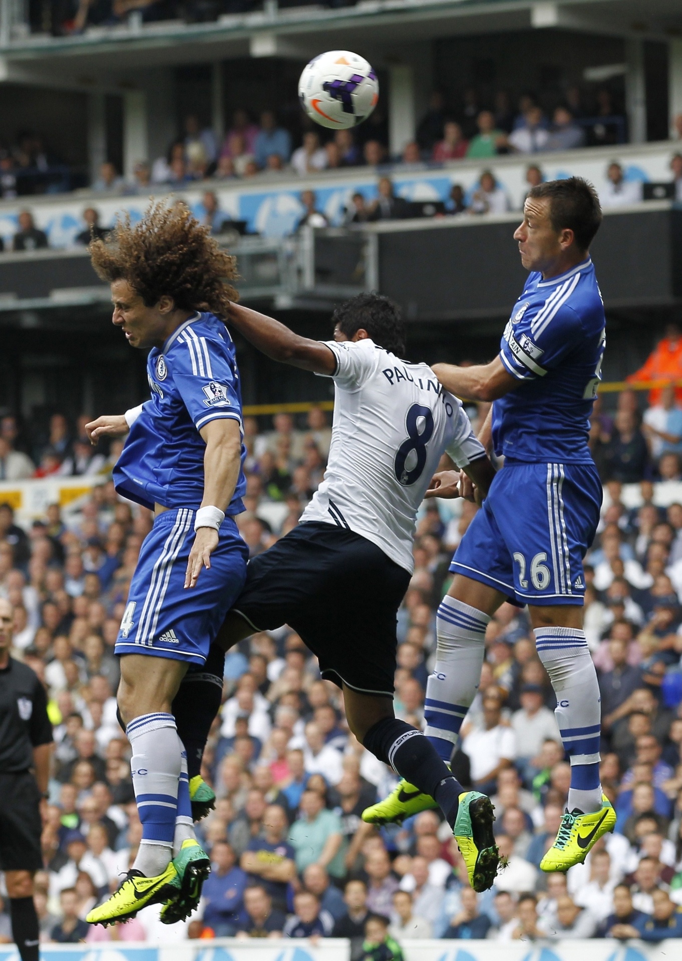 28.set.2013 - Paulinho, do Tottenham, briga pela bola em jogada com David Luiz e John Terry, do Chelsea - AFP PHOTO/ IAN KINGTON