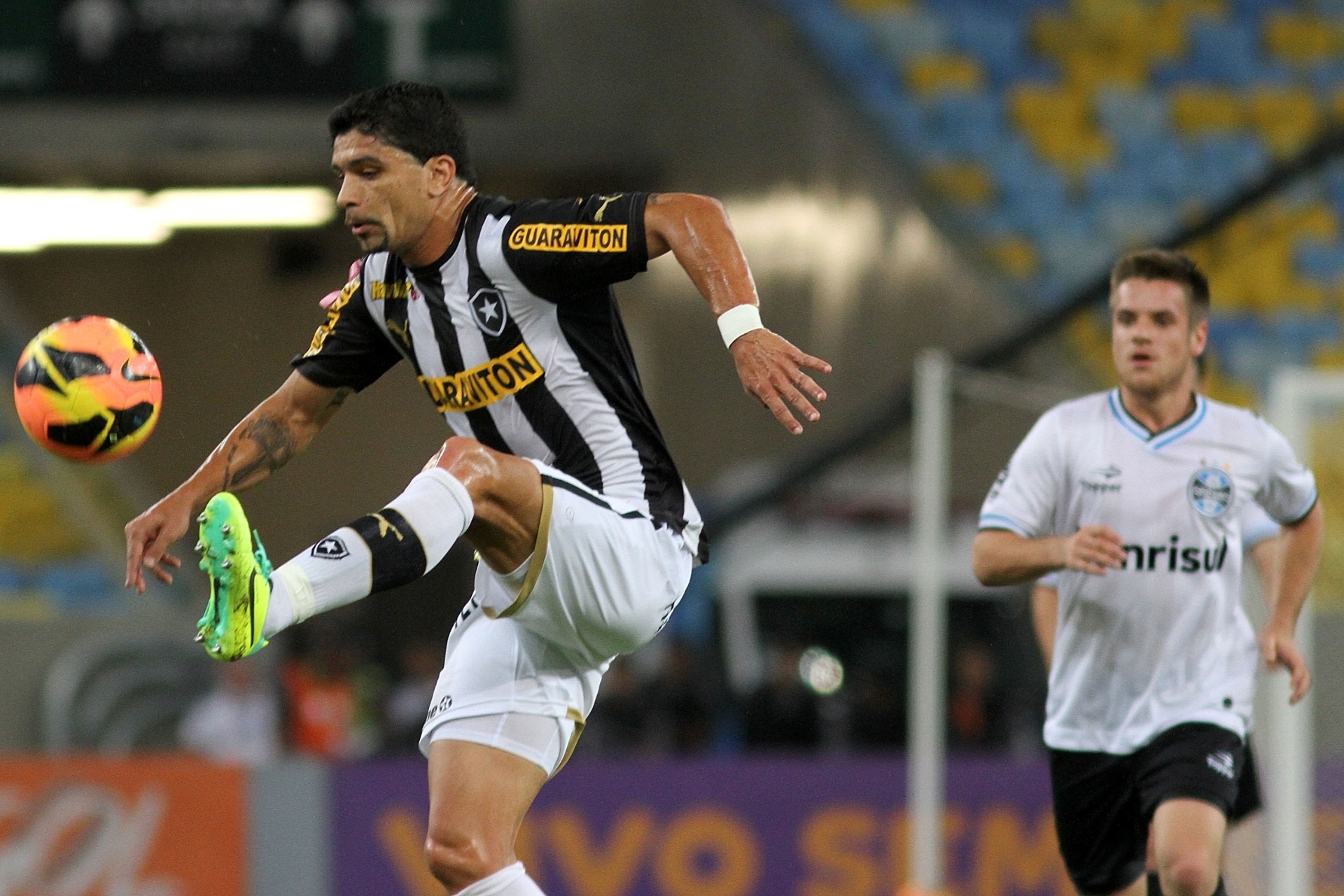 05.out.2013 - Observado por Ramiro, do Grêmio, meio-campista Renato, do Botafogo, domina a bola durante jogo no Maracanã - Vitor Silva/SSPress