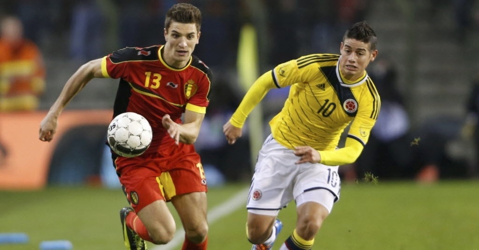 Thomas Meunier, da Bélgica, e James Rodríguez, da Colômbia, correm atrás da bola em amistoso em Bruxelas