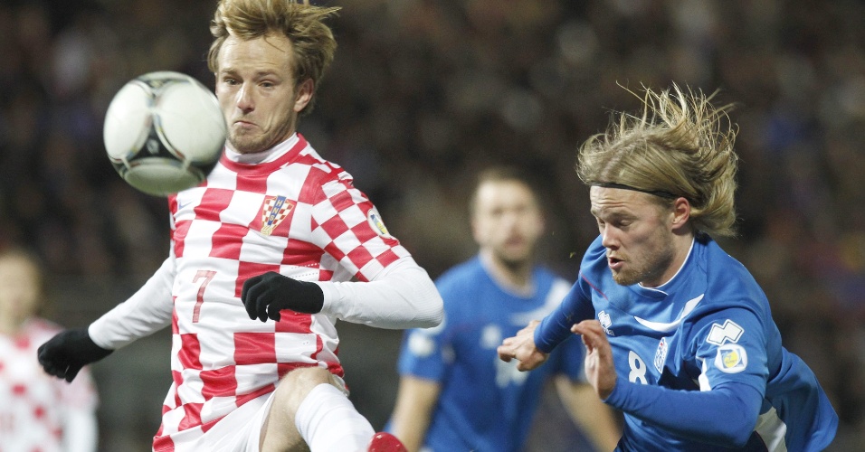15.nov.2013 - Observado por Birkir Bjärnason (d), da Islândia, Ivan Rakitic domina a bola no duelo de ida da repescagem europeia para a Copa-2014; jogo terminou empatado por 0 a 0