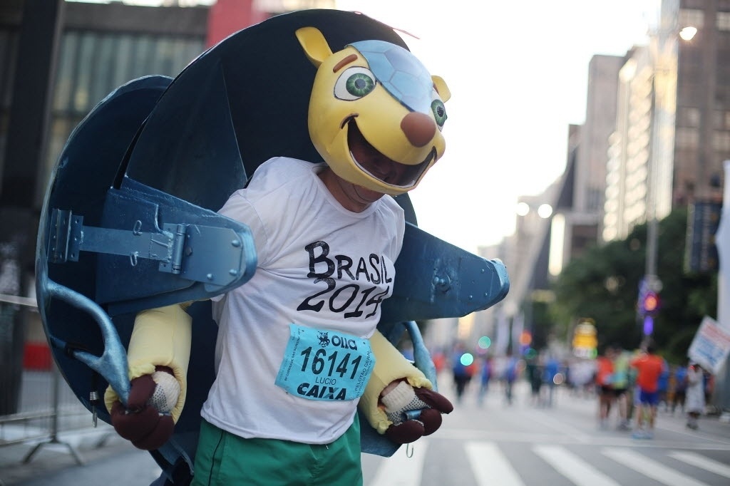 31. dez. 2013 - Homem se veste de Fuleco e chama a atenção durante a São Silvestre 2013 - Xinhua/ Rahel Patrasso