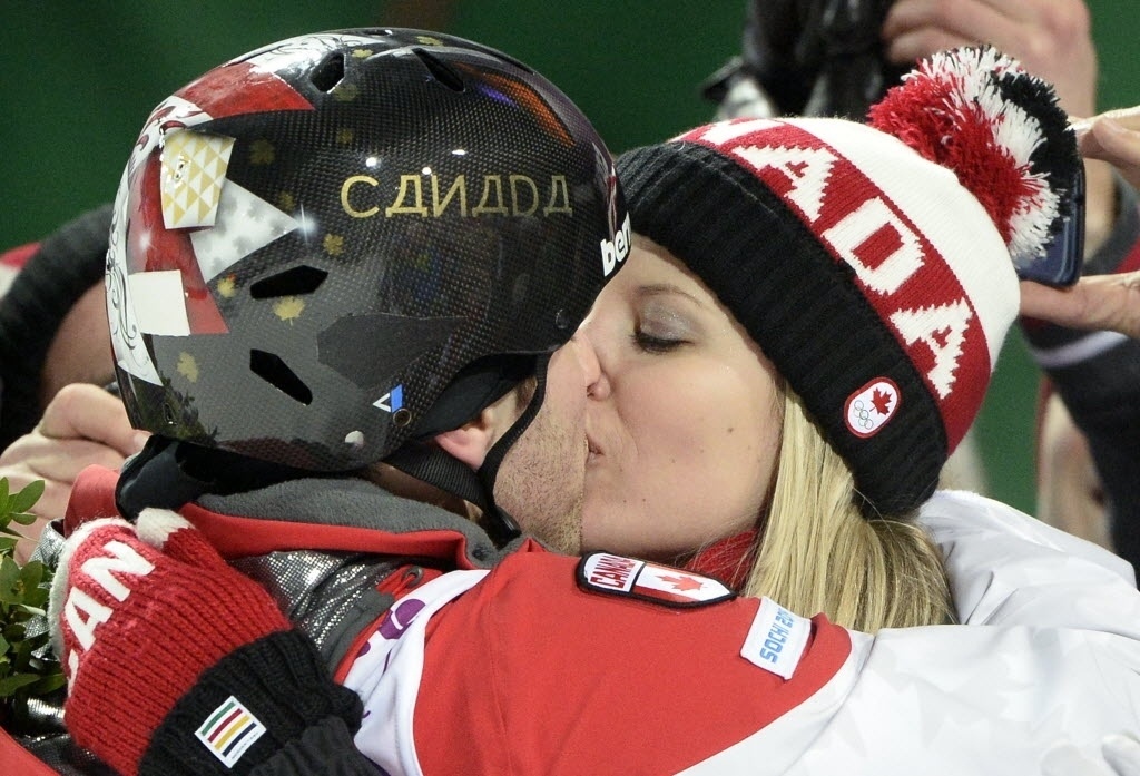 10.fev.2014 - Alex Bilodeau, canadense que levou o ouro no esqui estilo livre moguls, beija sua namorada Sabrina Bizier para celebrar a conquista - AFP PHOTO / FRANCK FIFE