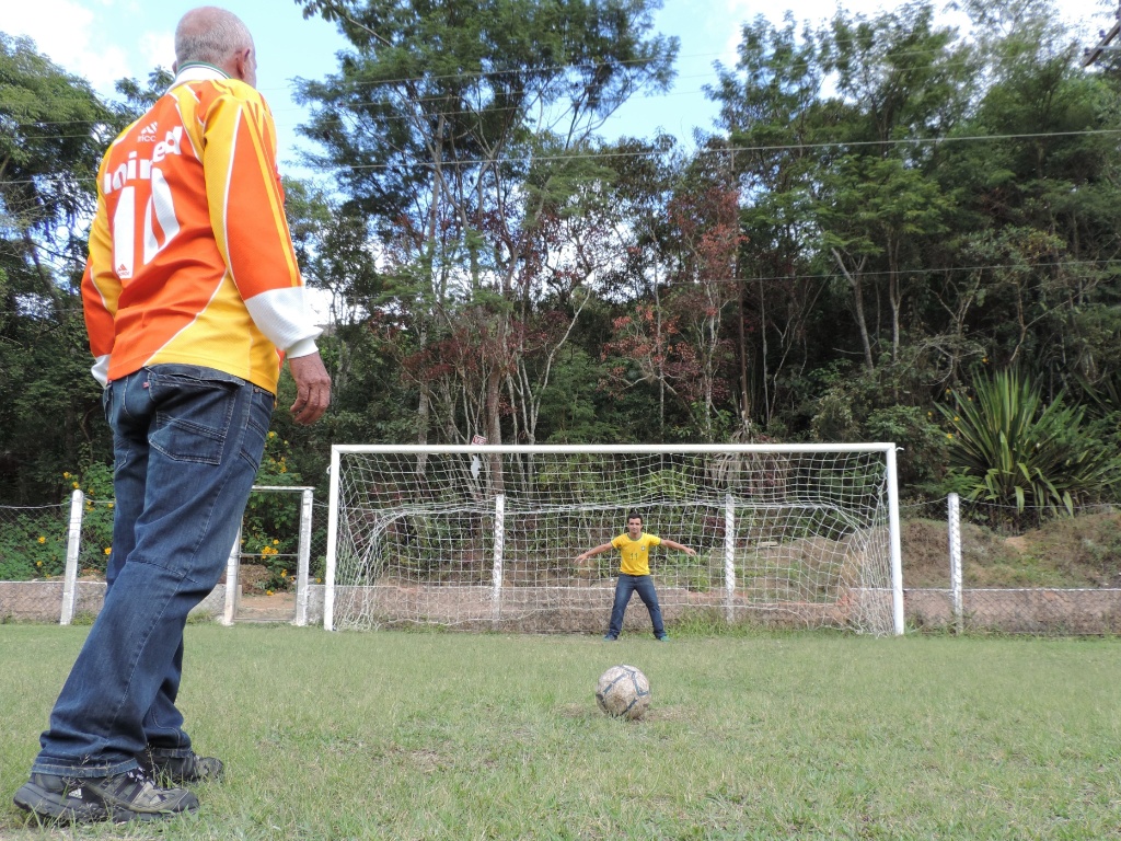 Seu Clóvis cobra pênalti no campo em que dava aulas de futebol para crianças antes das chuvas de 2011