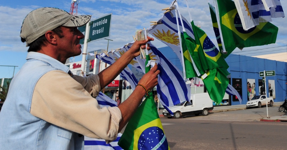 Ambulantes aproveitam expectativa do início da Copa para vender bandeiras de Uruguai e Brasil na fronteira do Chuí