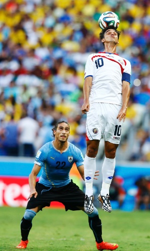 Imagine a cena sem a bola: não parece que o Cáceres vai ajudar o Bryan Ruiz, da Costa Rica, a fazer uma acrobacia?