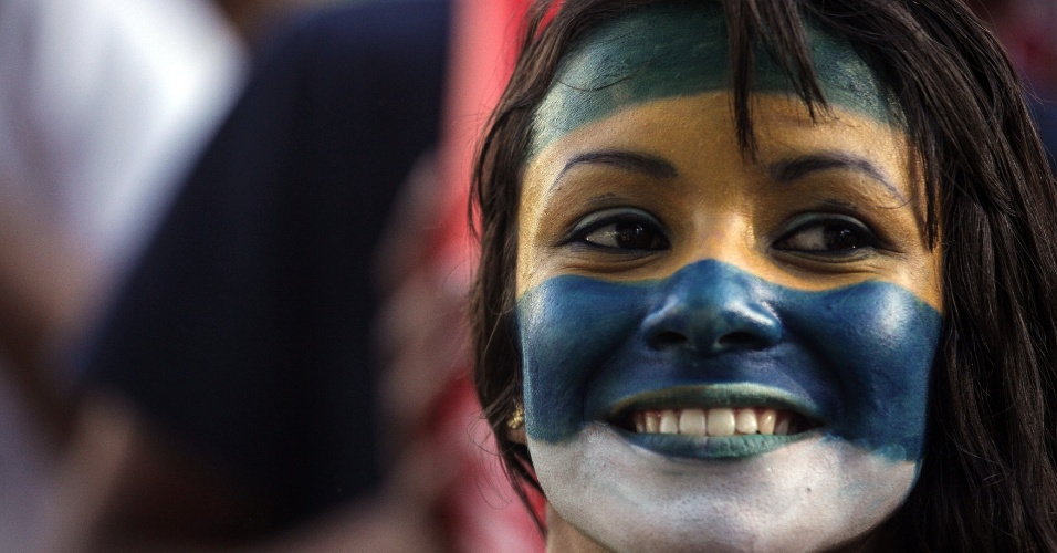 Torcedora brasileira pinta o rosto para curtir a Copa