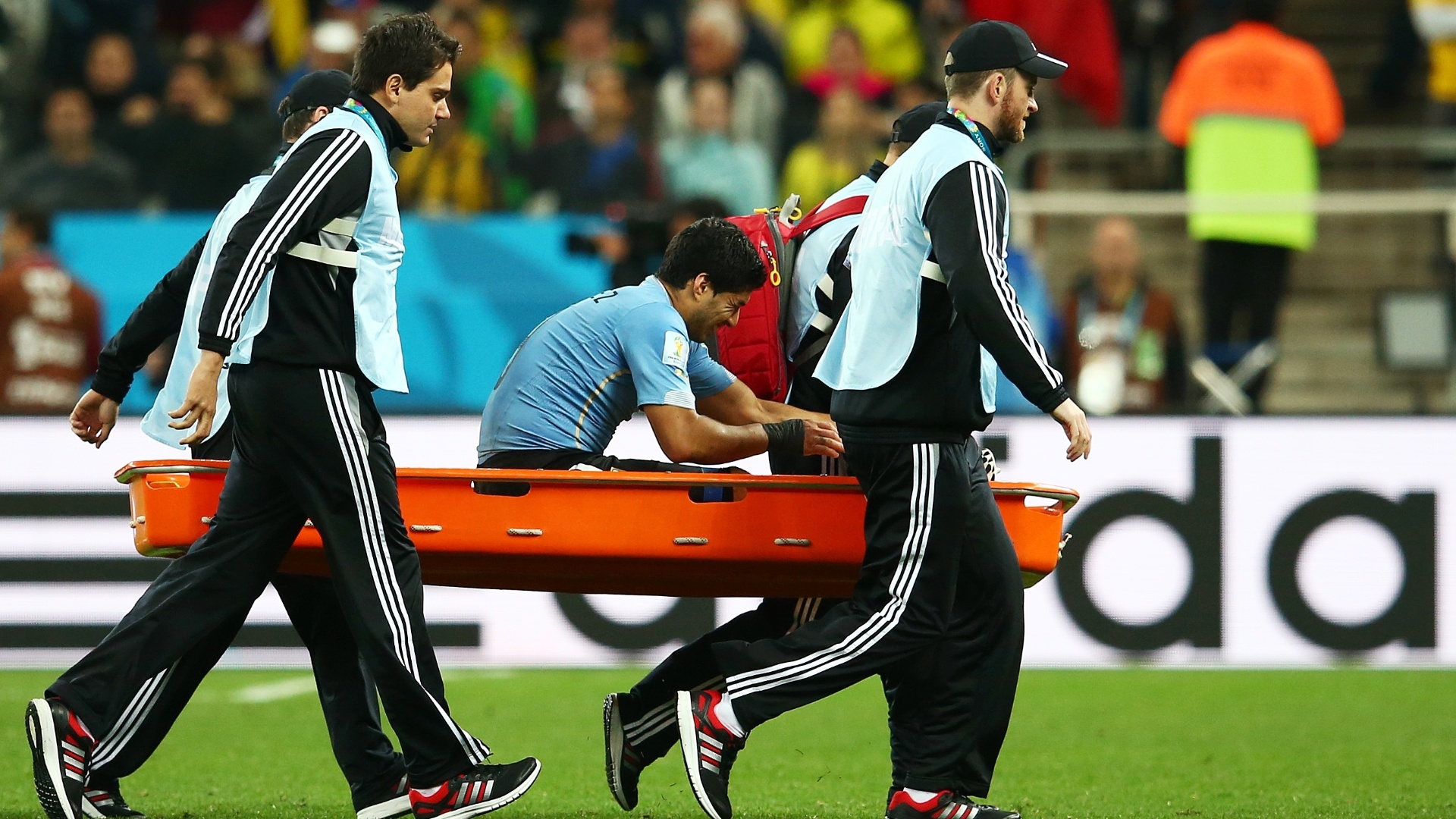 19.jun.2014 - Luis Suárez deixa o gramado de maca durante a vitória uruguaia. O atacante marcou os dois gols contra a Inglaterra
