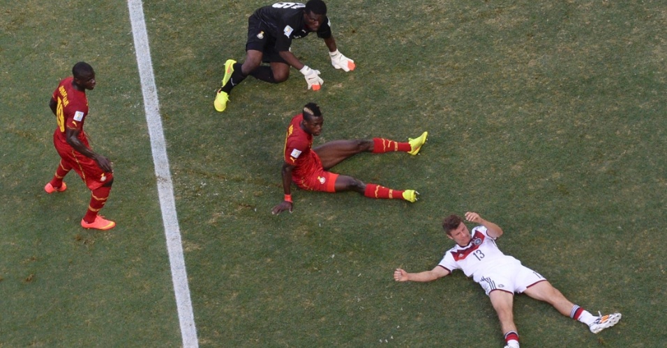 21.jun.2014 - Thomas Müller, da Alemanha, e John Boye, de Gana, ficam caídos no gramado durante a partida no Castelão