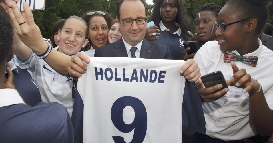 30.jun.2014 - Presidente francês François Hollande recebe camisa da seleção com seu nome e o número 9 nas costas