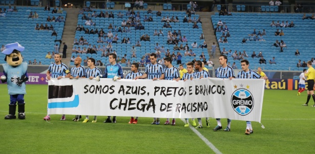 Jogadores do Grêmio entram em campo para o jogo com o Bahia com faixa contra o racismo - Divulgação/Grêmio