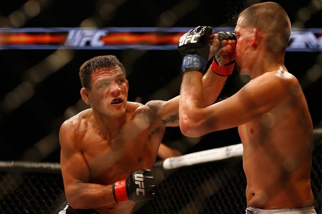 14.dez.2014 - Rafael dos Anjos acerta golpe no rosto de Nate Diaz, durante no UFC: Cigano x Miocic; brasileiro venceu por decisão unânime dos juízes e pediu para disputar o cinturão dos leves, hoje com Anthony Pettis - Christian Petersen/Getty Images/AFP