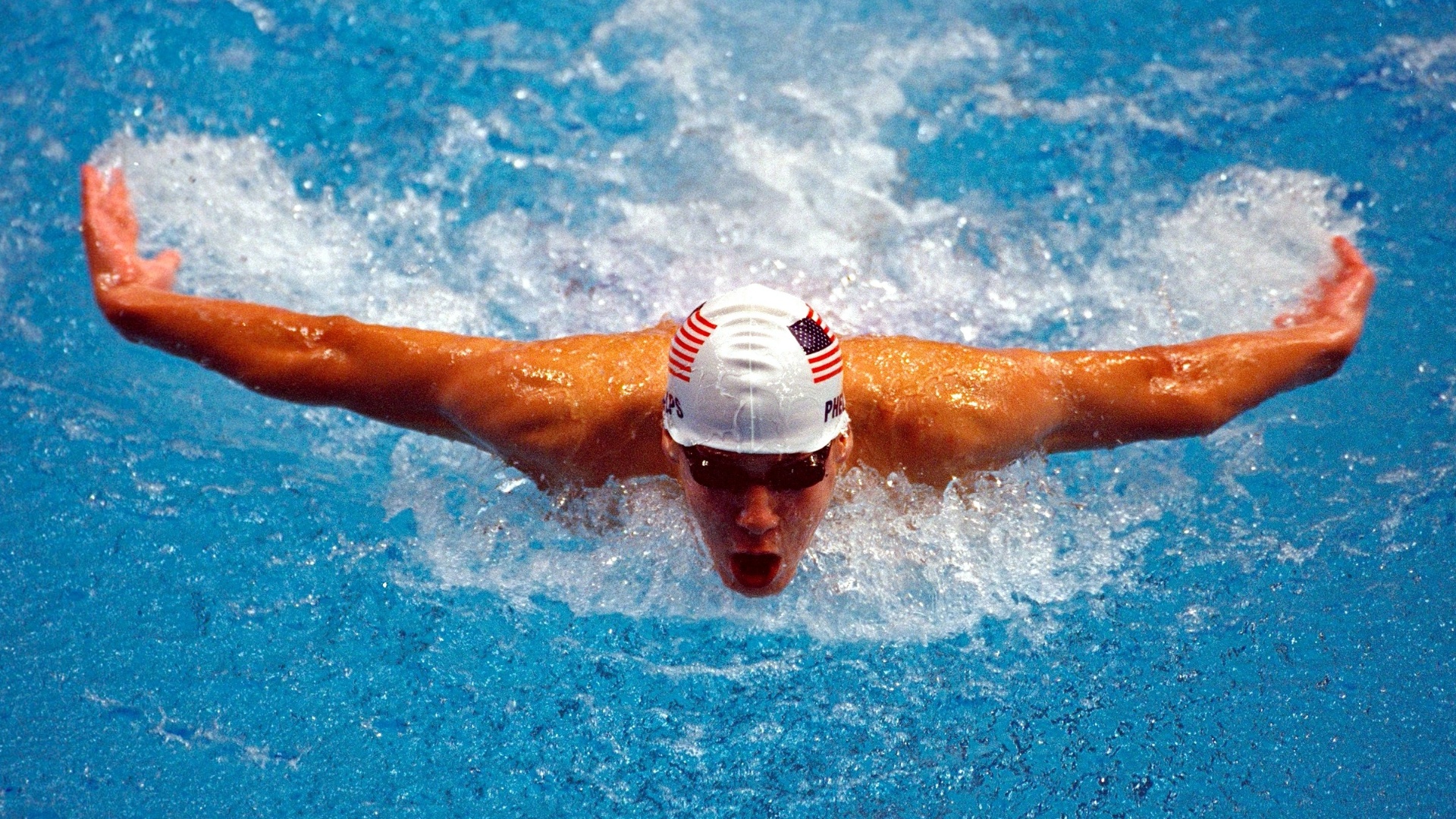 Michael Phelps em sua primeira vez nos Jogos Olímpicos, nas eliminatórias dos 200m borboleta em Sydney-2000