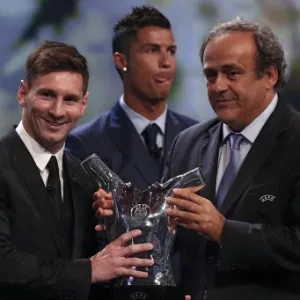 Com Cristiano Ronaldo ao fundo, Lionel Messi recebe o prêmio de melhor da Europa das mãos de Michel Platini, presidente da Uefa - VALERY HACHE/AFP