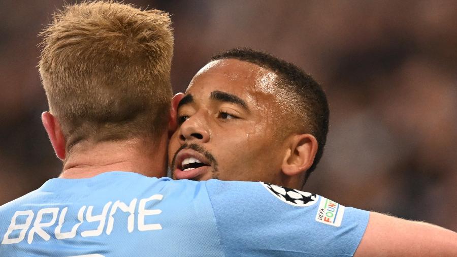 De Bruyne e Gabriel Jesus se abraçam durante Manchester City x Real Madrid, válido pela semifinal da Champions League - Paul ELLIS / AFP