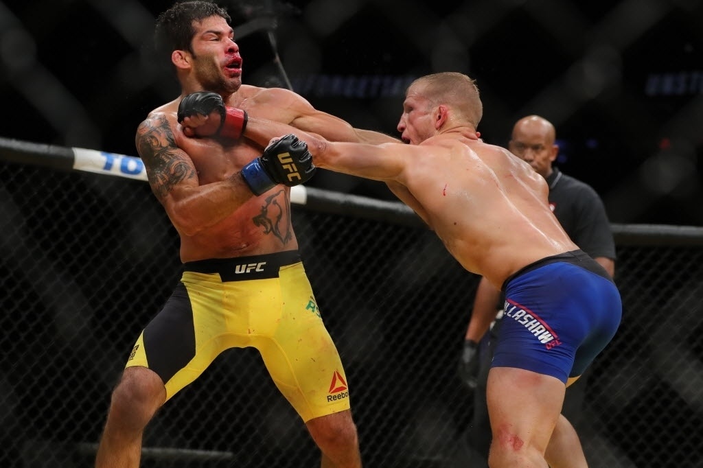 Raphael Assunção leva soco de T.J. Dillashaw na quinta luta do card preliminar do UFC 200. Brasileiro acabou derrotado por decisão dos juízes - Rey Del Rio/Getty Images/AFP