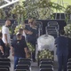 Edinho, Pele's son, is embraced after leaving the coffin in the middle of the lawn at Villa Belmero - Marcelo Justo/UOL