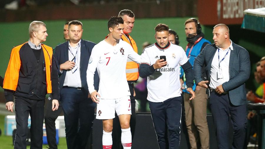 Torcedor invade o campo para tirar foto com Cristiano Ronaldo em jogo da seleção portuguesa - Ints Kalnins/Reuters