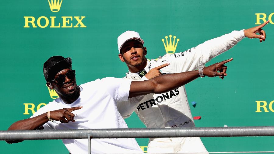 Usain Bolt e Lewis Hamilton no pódio do GP dos EUA - Mark Thompson/Getty Images