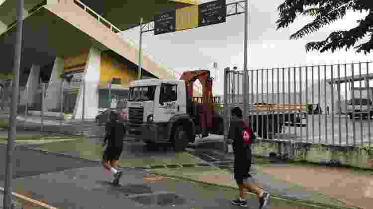Homens correm em frente ao hospital de campanha que está sendo montado no Maracanã - Bruno Braz / UOL Esporte