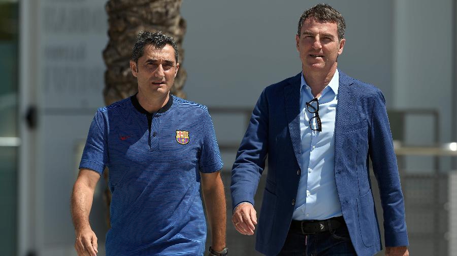 O técnico Ernesto Valverde (esq.) e o dirigente Robert Fernández (dir.) caminham no CT do Barcelona - Lluis Gene/AFP