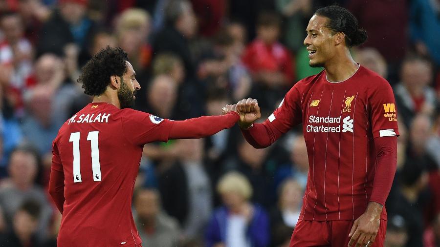 Salah e Van Dijk comemorando gol do Liverpool contra o Norwich pelo Campeonato Inglês - Oli SCARFF / AFP