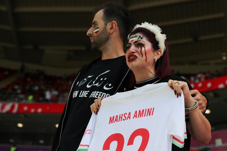 An Iranian fan cries in the stands during a protest to commemorate Mahsa Amini's death in the stands of Wales vs Iran - Fantasista/Getty Images - Fantasista/Getty Images