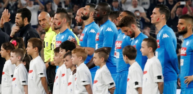 Jogadores do Napoli exibem marca vermelha no rosto em campanha da liga local - Stefano Rellandini/Reuters