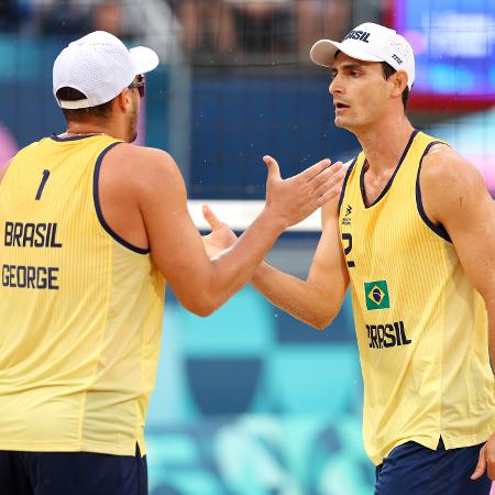 André e George, do Brasil, celebram ponto sobre a dupla de Marrocos no vôlei de praia masculino das Olimpíadas