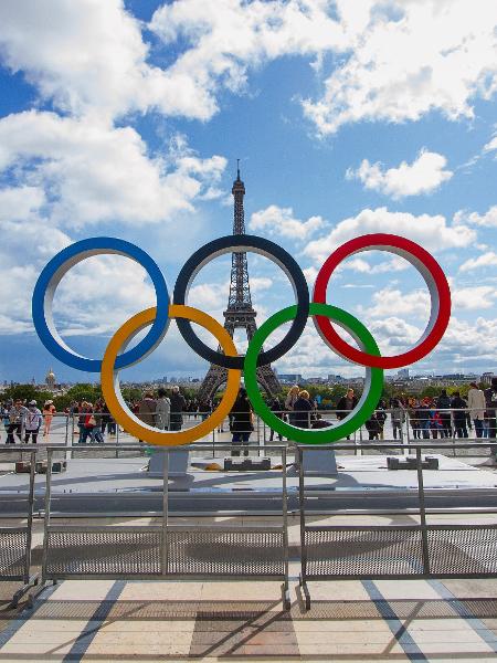 Anéis olímpicos na frente da Torre Eiffel, em Paris; Olimpíadas começam em julho