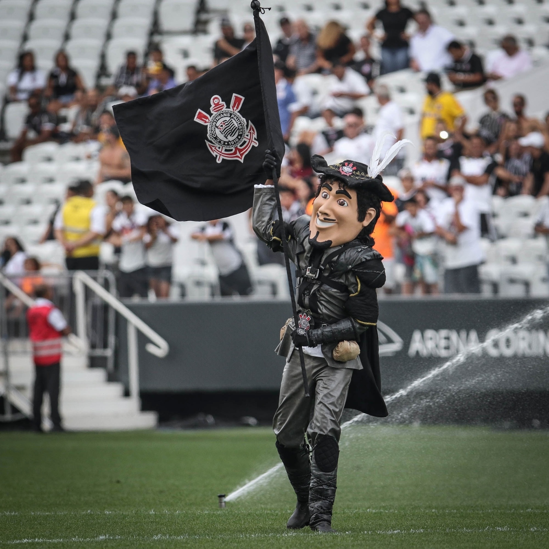 Mascote do Corinthians ostenta a bandeira do clube no gramado da Arena antes do clássico contra o São Paulo pelo Paulistão - Ricardo Nogueira/Folhapress