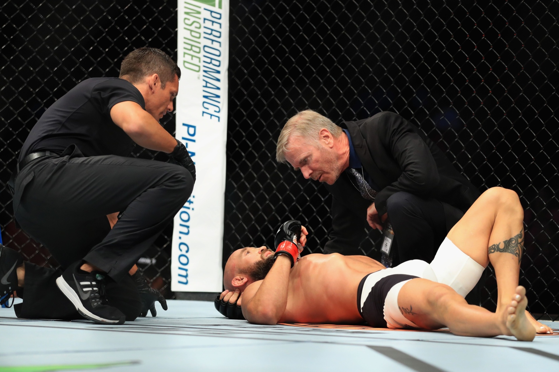Joshua Berkman estirado no octógono após derrota para Drew Dober no card preliminar do UFC 214 - Sean M. Haffey/Getty Images/AFP