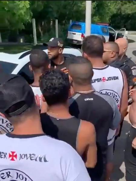 Fellipe Bastos (de boné preto, ao centro) conversa com manifestantes "escoltado" por policiais na porta do CT - Reprodução / Twitter @colina_informa