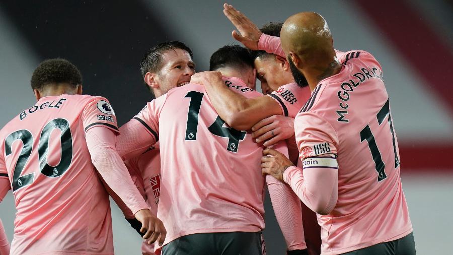 Jogadores do Sheffield comemoram o segundo gol contra o Manchester United - TIM KEETON/AFP
