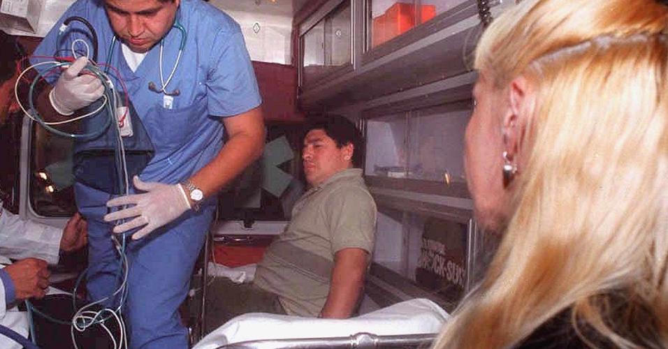 Diego Maradona é transportado em ambulância para hospital em Buenos Aires, acompanhado pela mulher, Claudia Villafane, em 9 de janeiro de 2000, após ficar 5 dias internado em hospital no Uruguai para tratar dependência química 