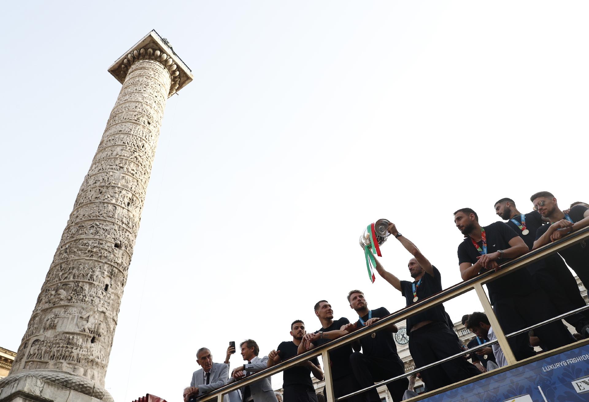 Soccer Football - Euro 2020 - The Italy team drive through Rome on a open top bus tour after they won Euro 2020 - Rome, Italy - July 12, 2021 Italy's Giorgio Chiellini lifts the trophy on the bus during the tour REUTERS/Guglielmo Mangiapane - GUGLIELMO MANGIAPANE/REUTERS